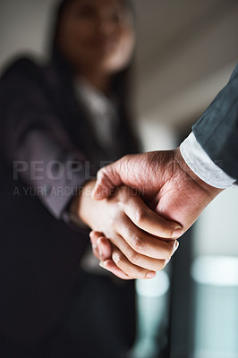 Buy stock photo Cropped shot of two unrecognizable businesspeople shaking hands in an office