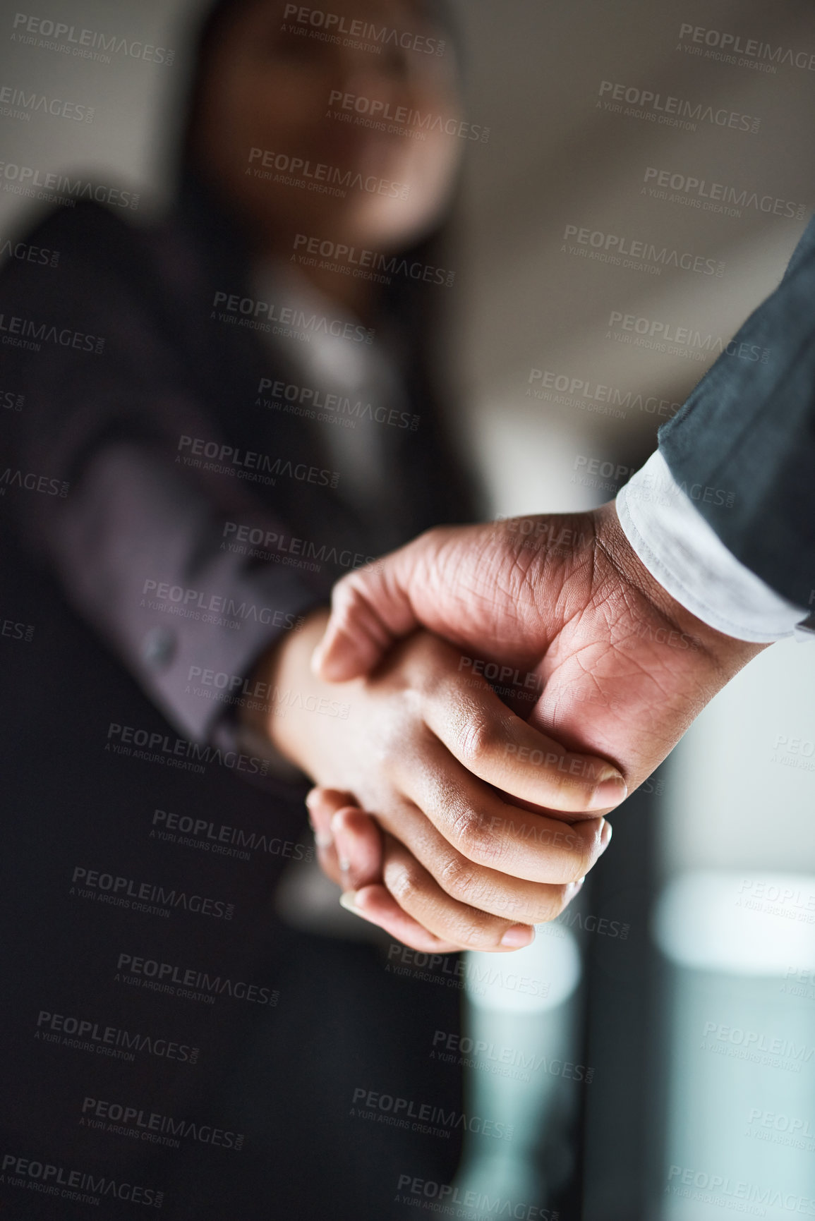 Buy stock photo Cropped shot of two unrecognizable businesspeople shaking hands in an office