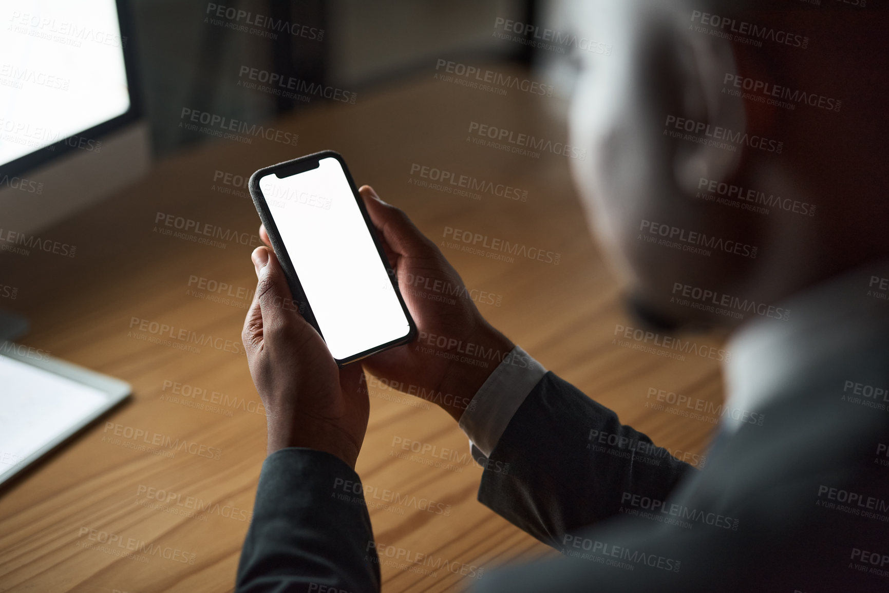 Buy stock photo Cropped shot of an unrecognizable person using their phone in the office