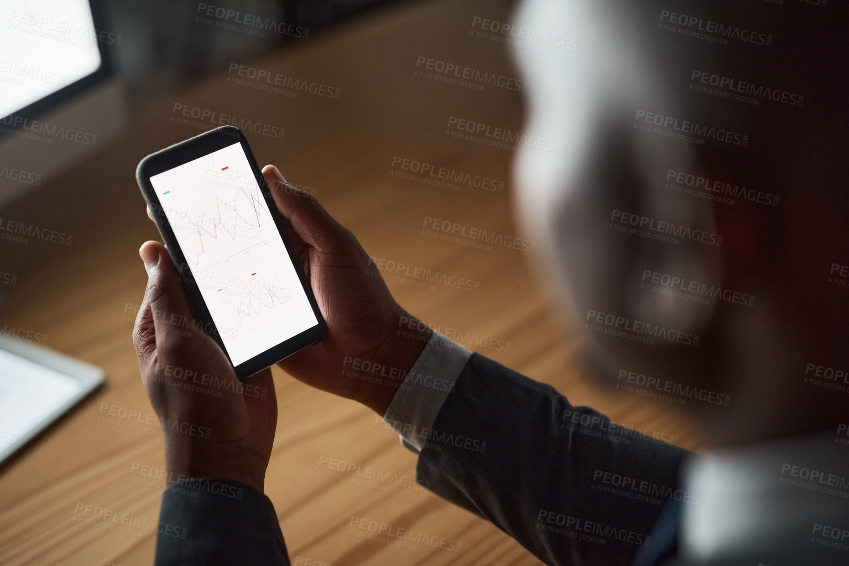 Buy stock photo Cropped shot of an unrecognizable person using their phone in the office