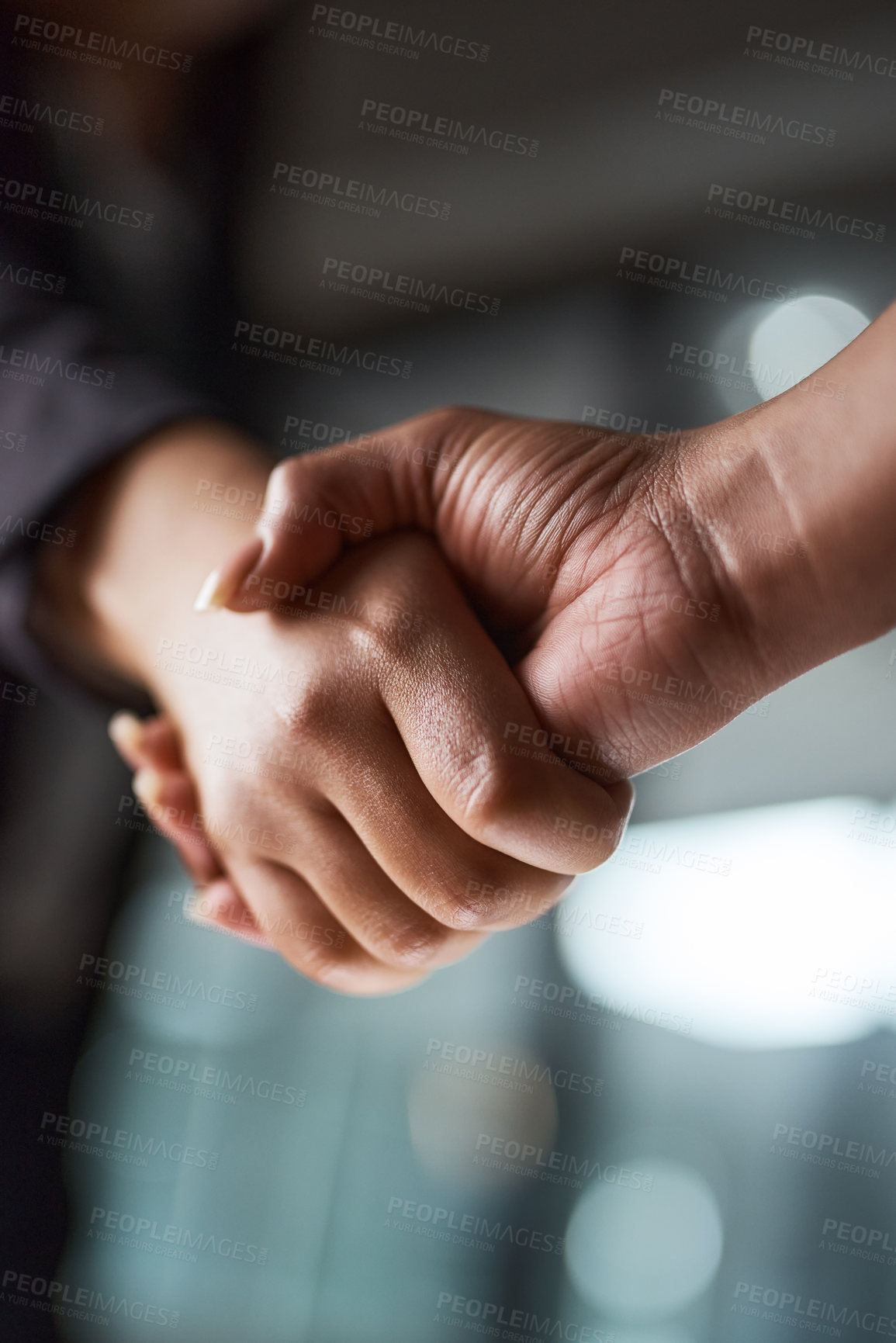 Buy stock photo Cropped shot of two unrecognizable businesspeople shaking hands in an office