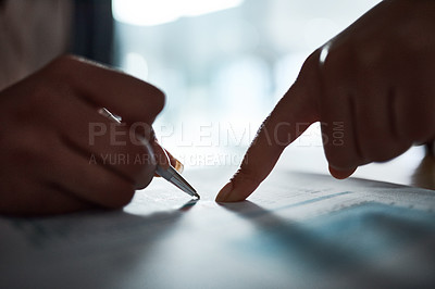 Buy stock photo Cropped shot of two businesspeople filling in paperwork in an office