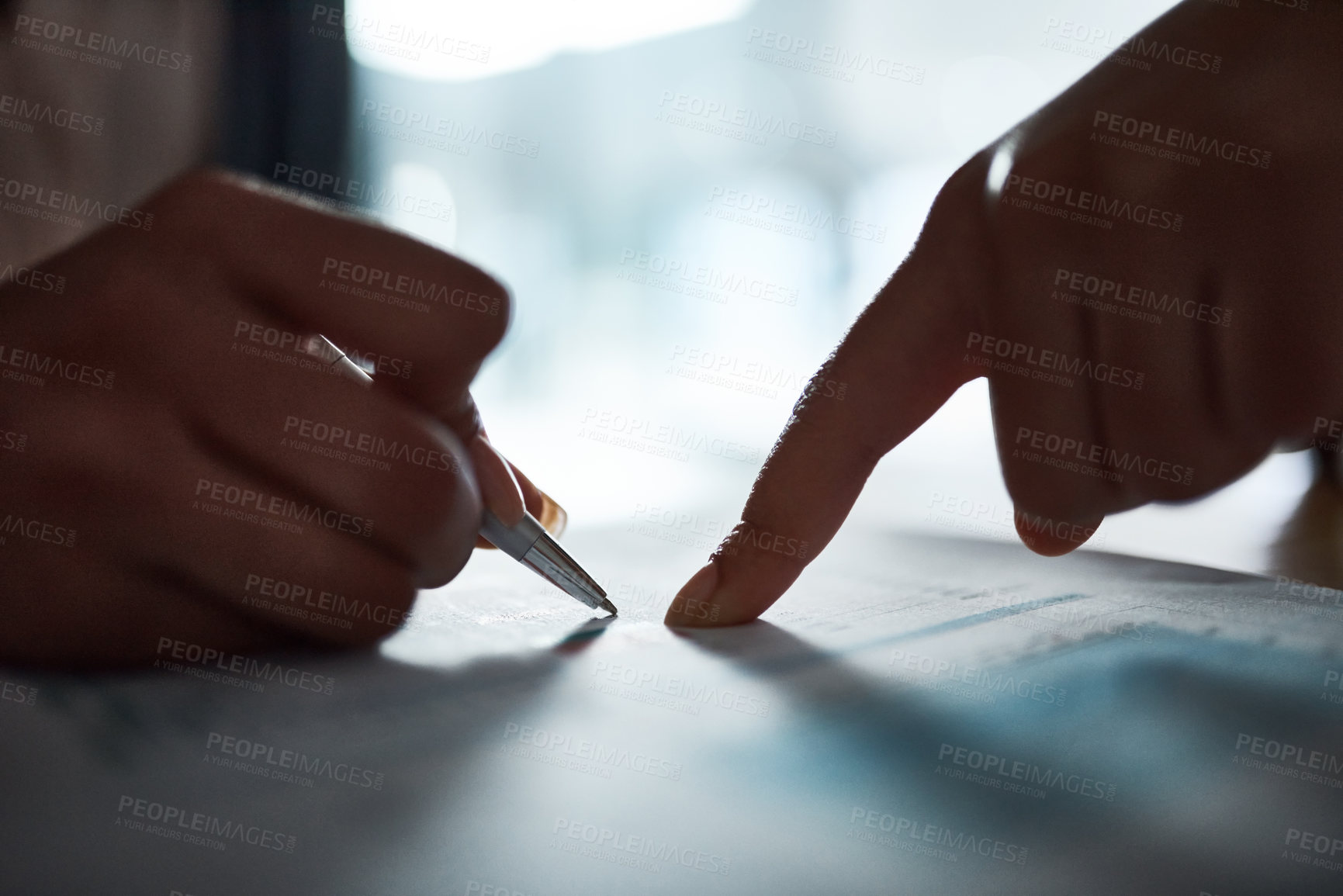 Buy stock photo Cropped shot of two businesspeople filling in paperwork in an office