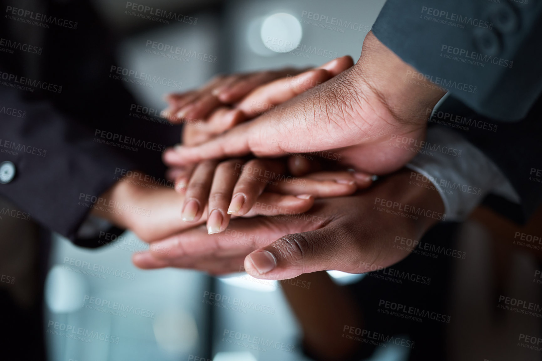 Buy stock photo Cropped shot of a group of unrecognizable businesspeople joining their hands together in a huddle