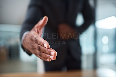 Buy stock photo Cropped shot of an unrecognizable businessman extending a handshake in an office