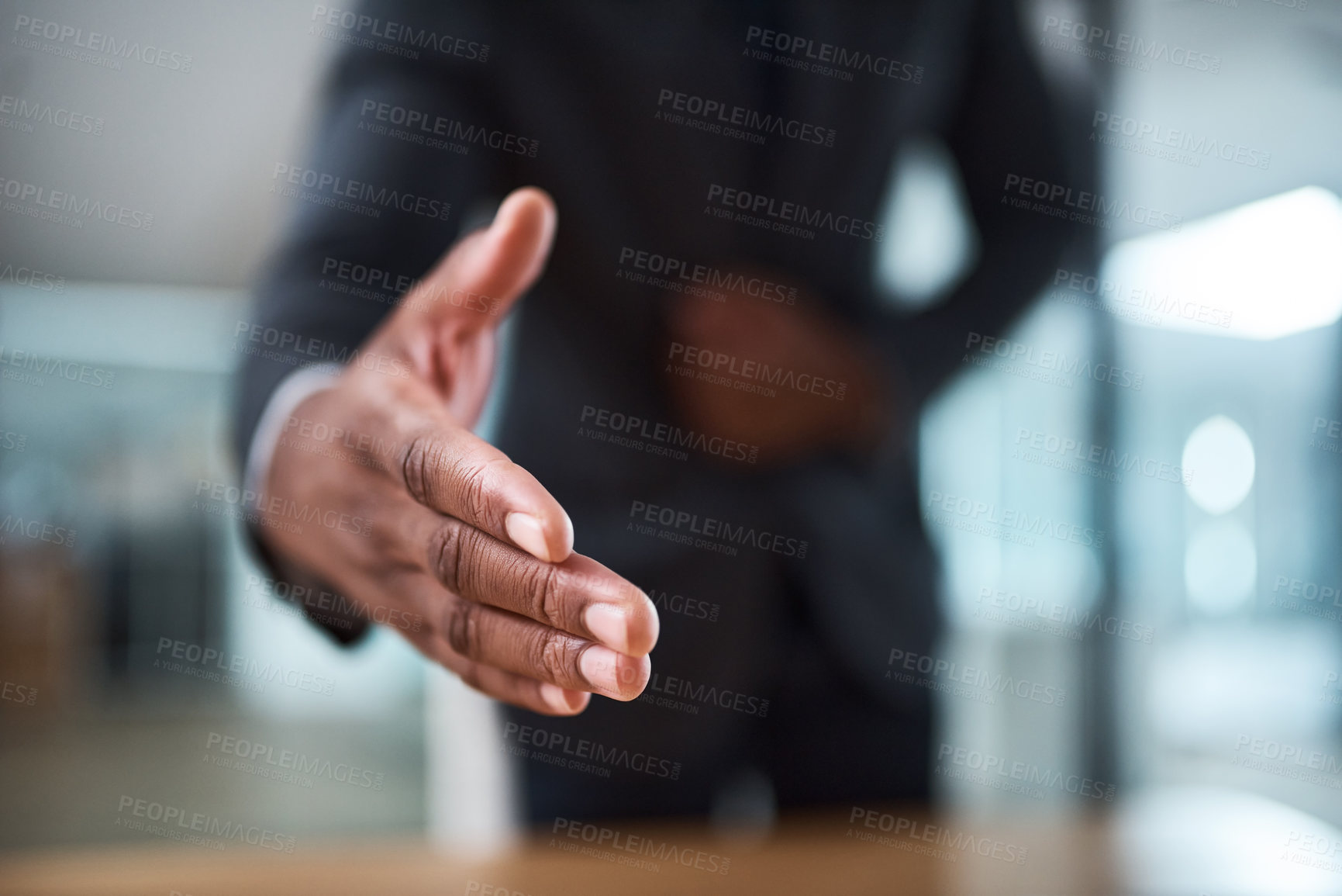 Buy stock photo Cropped shot of an unrecognizable businessman extending a handshake in an office