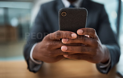 Buy stock photo Cropped shot of an unrecognizable businessman using a cellphone in an office
