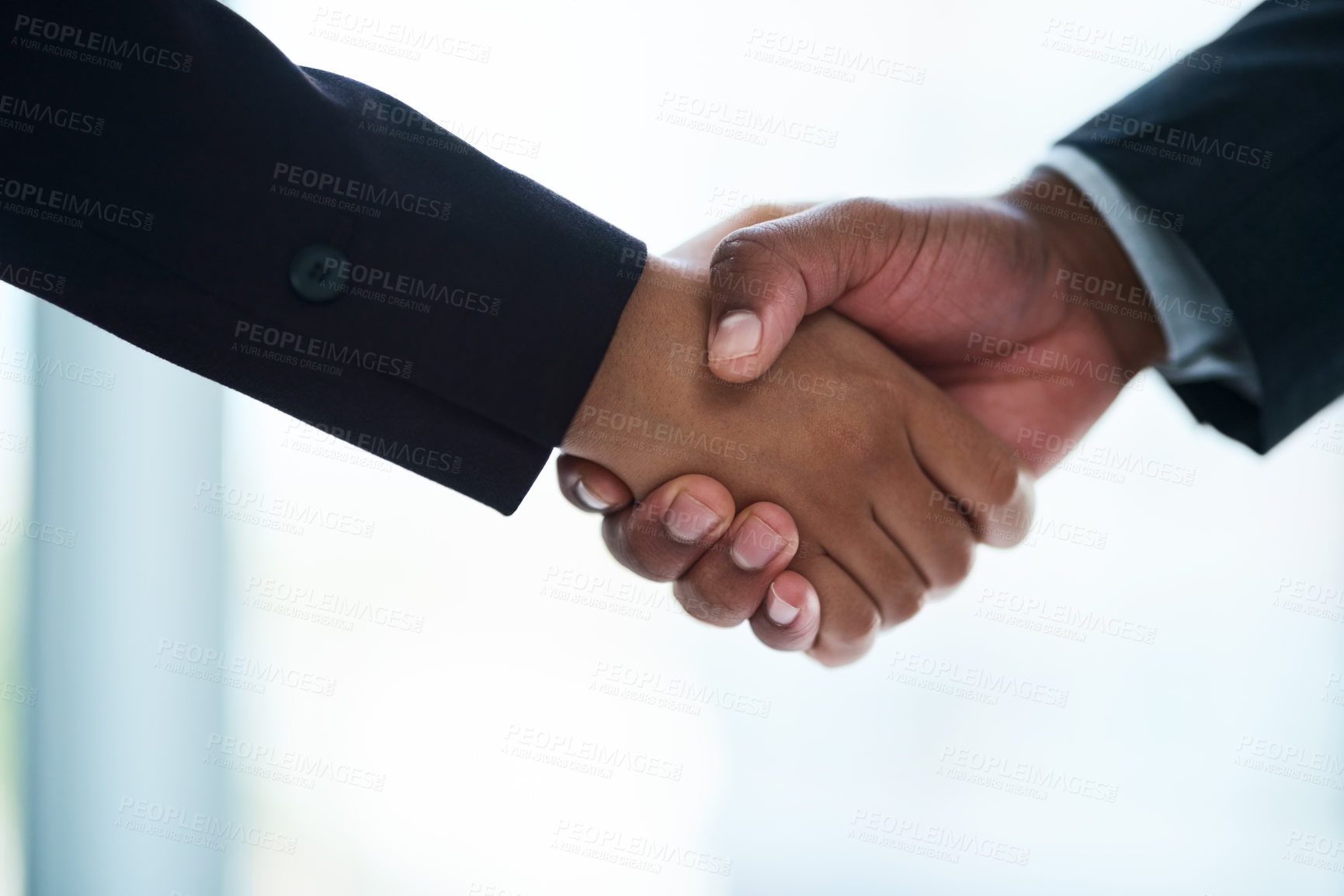 Buy stock photo Cropped shot of two unrecognizable businesspeople shaking hands in an office