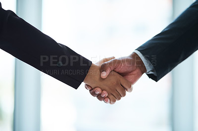 Buy stock photo Cropped shot of two unrecognizable businesspeople shaking hands in an office