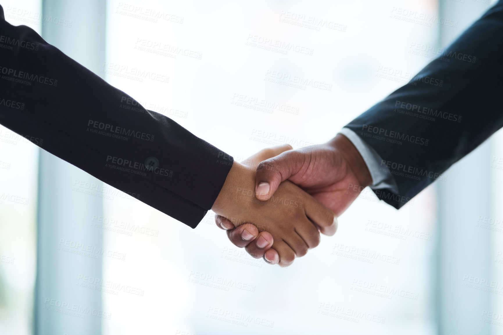 Buy stock photo Cropped shot of two unrecognizable businesspeople shaking hands in an office