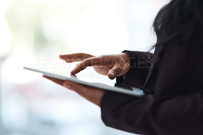 Buy stock photo Closeup shot of an unrecognizable businesswoman using a tablet in an office