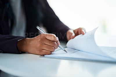 Buy stock photo Cropped shot of a businessman filling in paperwork in an office