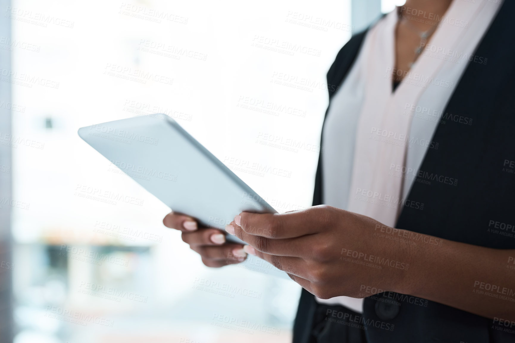 Buy stock photo Closeup shot of an unrecognizable businesswoman using a tablet in an office