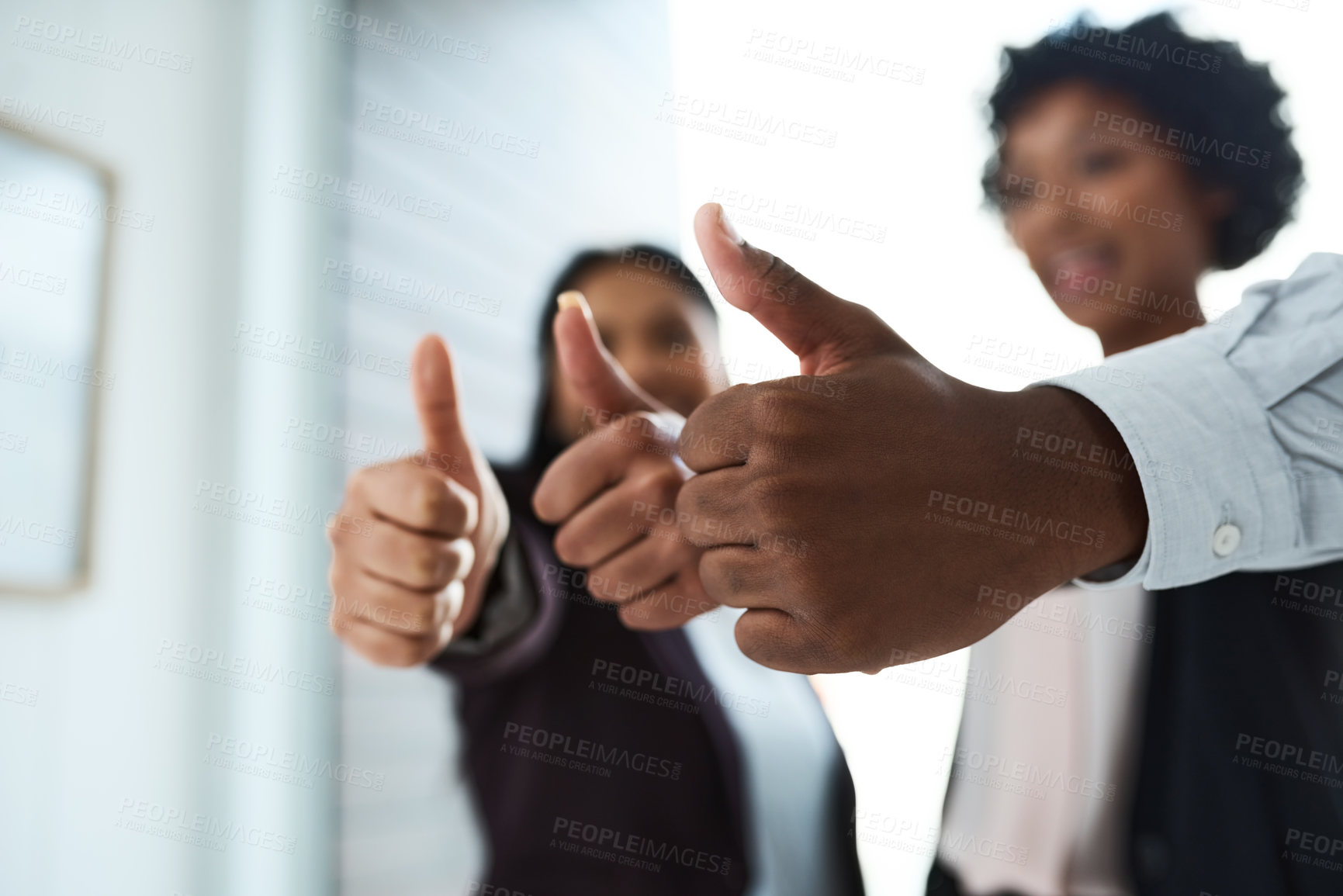 Buy stock photo Cropped shot of a group of unrecognizable businesspeople showing thumbs up in an office