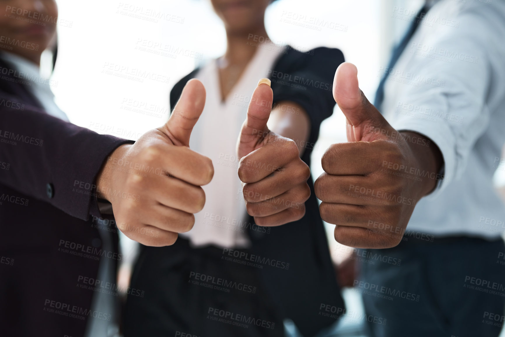 Buy stock photo Cropped shot of a group of unrecognizable businesspeople showing thumbs up in an office