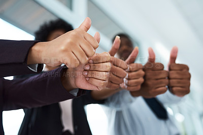 Buy stock photo Cropped shot of a group of unrecognizable businesspeople showing thumbs up in an office