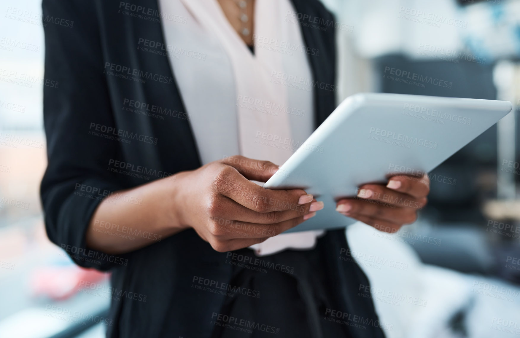 Buy stock photo Closeup shot of an unrecognizable businesswoman using a tablet in an office