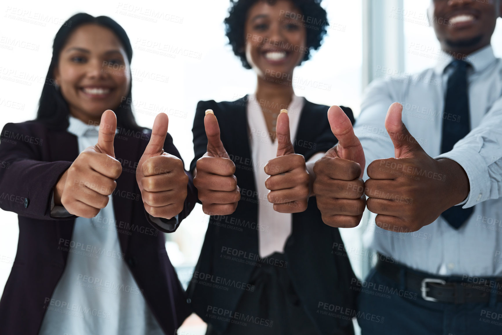 Buy stock photo Cropped shot of a group of unrecognizable businesspeople showing thumbs up in an office