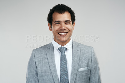 Buy stock photo Studio shot of a confident businessman standing against a grey background