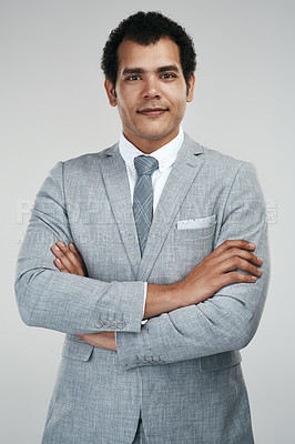 Buy stock photo Studio shot of a confident businessman standing against a grey background