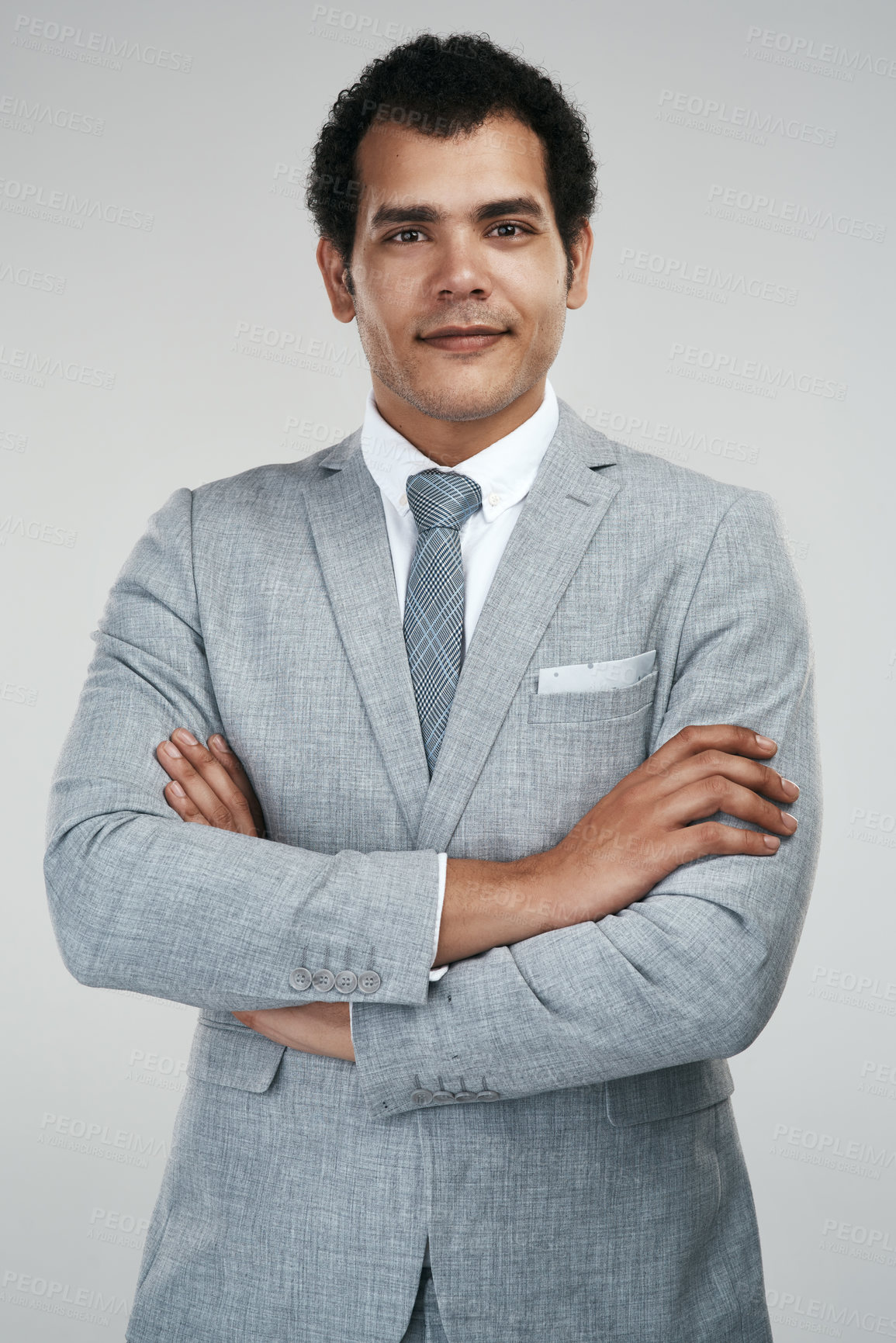 Buy stock photo Studio shot of a confident businessman standing against a grey background