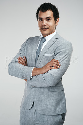 Buy stock photo Studio shot of a confident businessman standing against a grey background