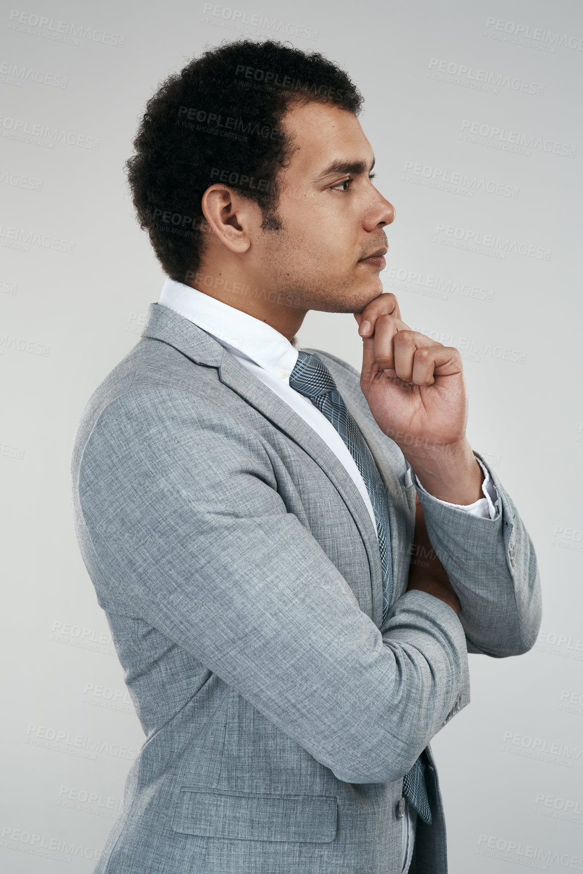 Buy stock photo Studio shot of a businessman looking thoughtful while standing against a grey background