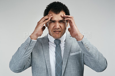 Buy stock photo Studio shot of a businessman looking stressed while standing against a grey background