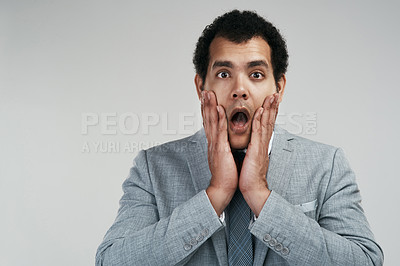 Buy stock photo Studio shot of a businessman looking worried while standing against a grey background