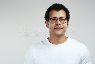 Buy stock photo Shot of a handsome young man standing against a grey background