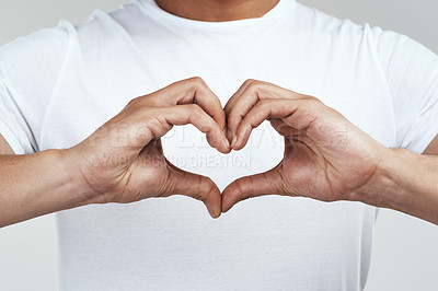 Buy stock photo Shot of an unrecognizable man forming a heart shape with his hands