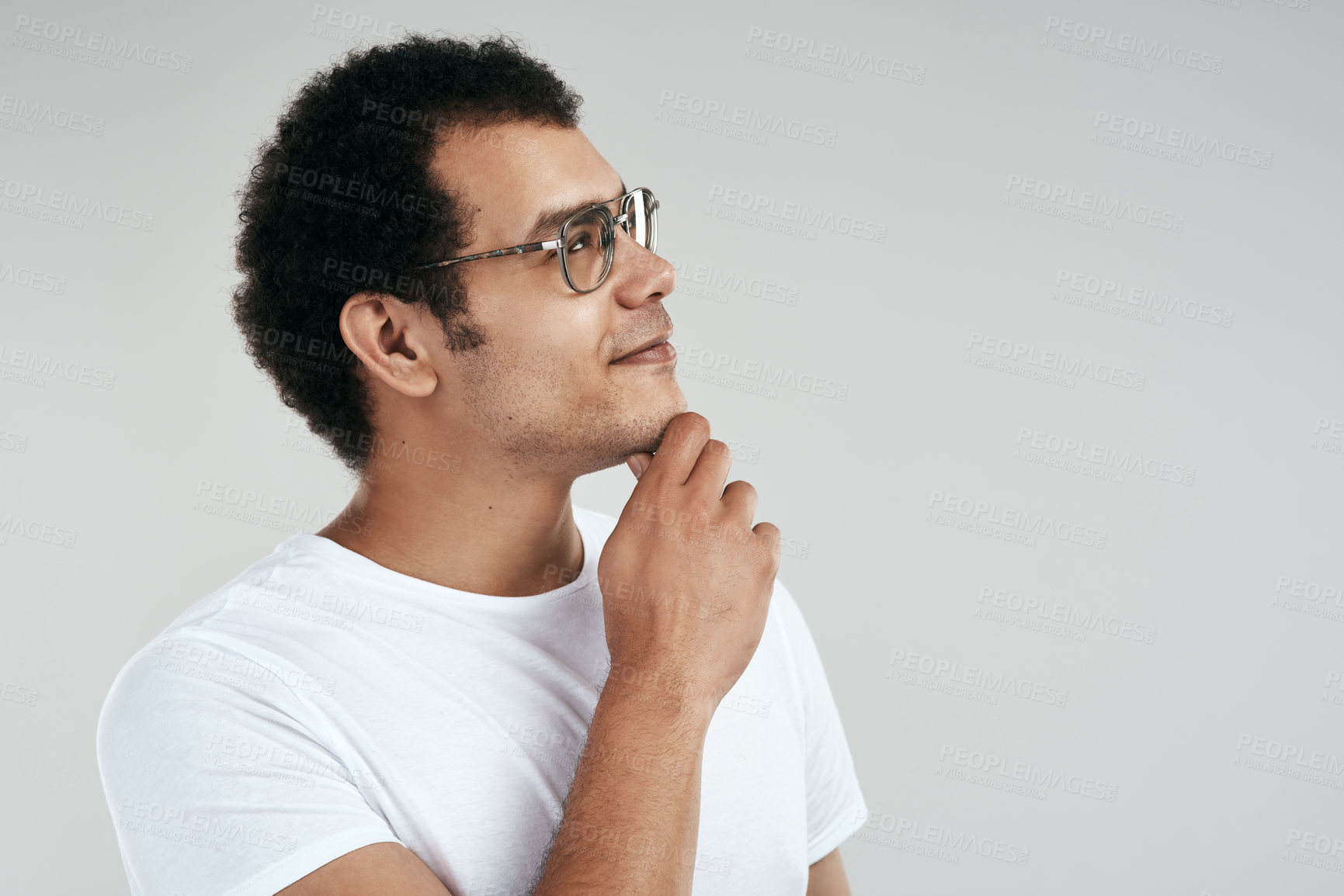 Buy stock photo Studio shot of a man looking thoughtful while standing against a grey background