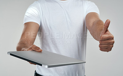 Buy stock photo Shot of an unrecognizable man showing thumbs up while holding a laptop
