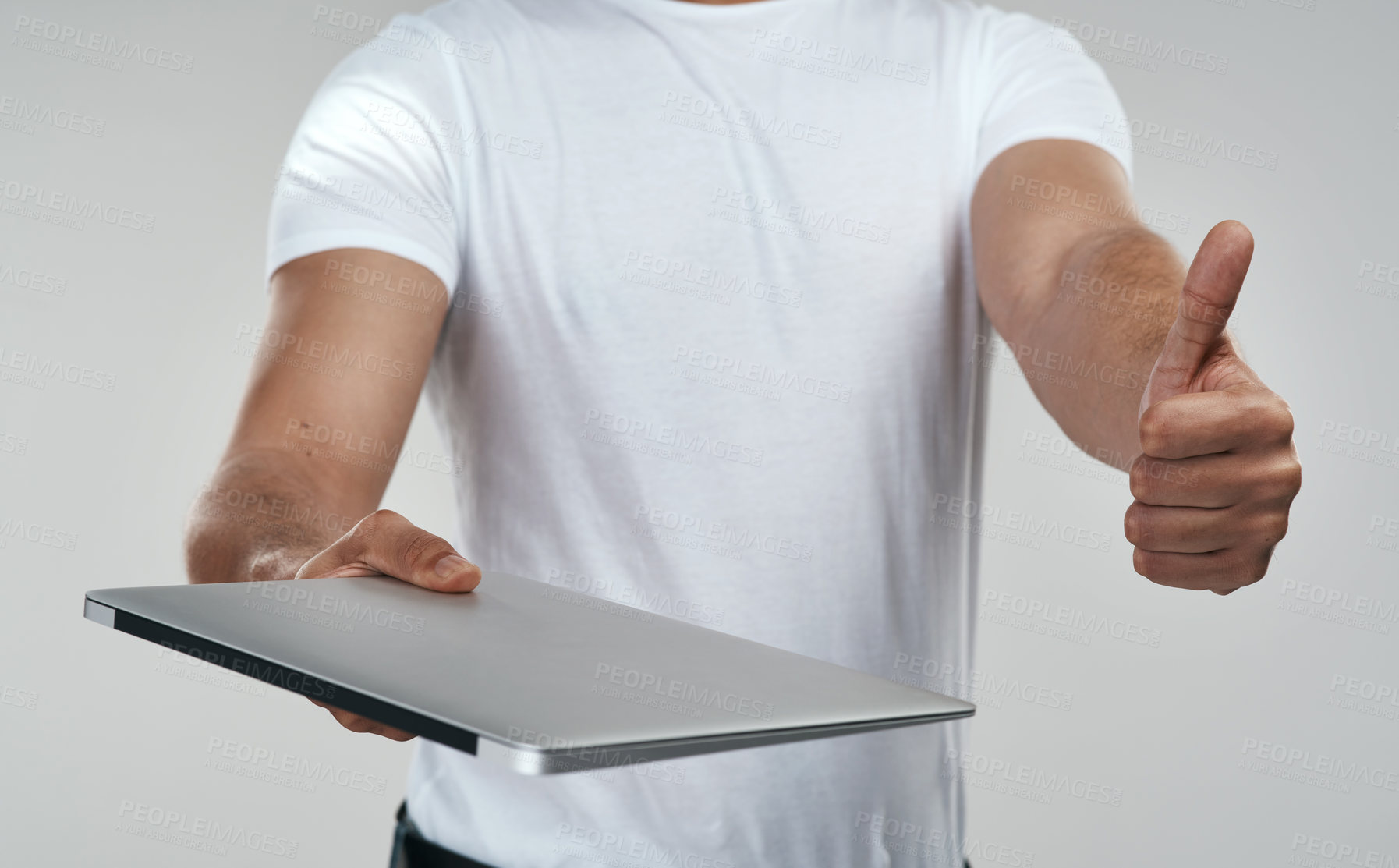 Buy stock photo Shot of an unrecognizable man showing thumbs up while holding a laptop