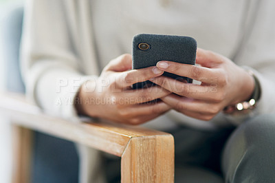Buy stock photo Closeup shot of an unrecognisable businesswoman using a cellphone in an office