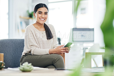 Buy stock photo Portrait of a young businesswoman using a cellphone in an office