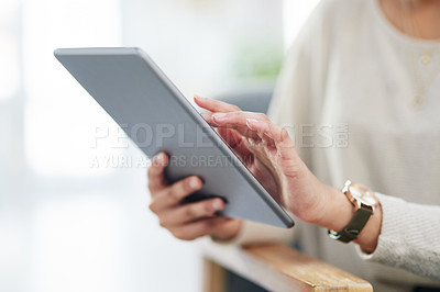 Buy stock photo Closeup shot of an unrecognisable businesswoman using a digital tablet in an office