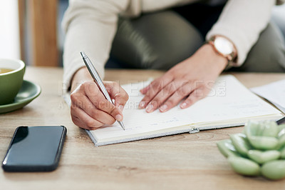 Buy stock photo Closeup shot of an unrecognisable businesswoman writing in a notebook in an office