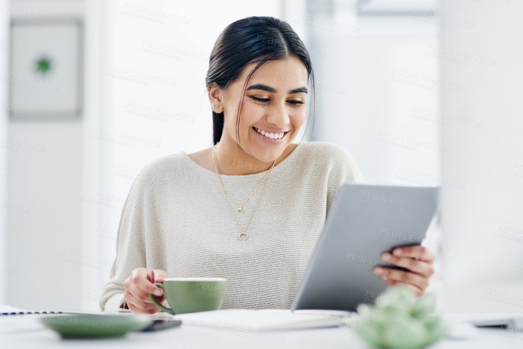 Buy stock photo Shot of a young businesswoman using a digital tablet in an office