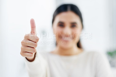 Buy stock photo Closeup shot of a young businesswoman showing thumbs up in an office