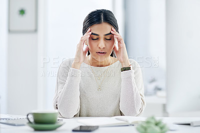 Buy stock photo Shot of a young businesswoman looking stressed out while working in an office