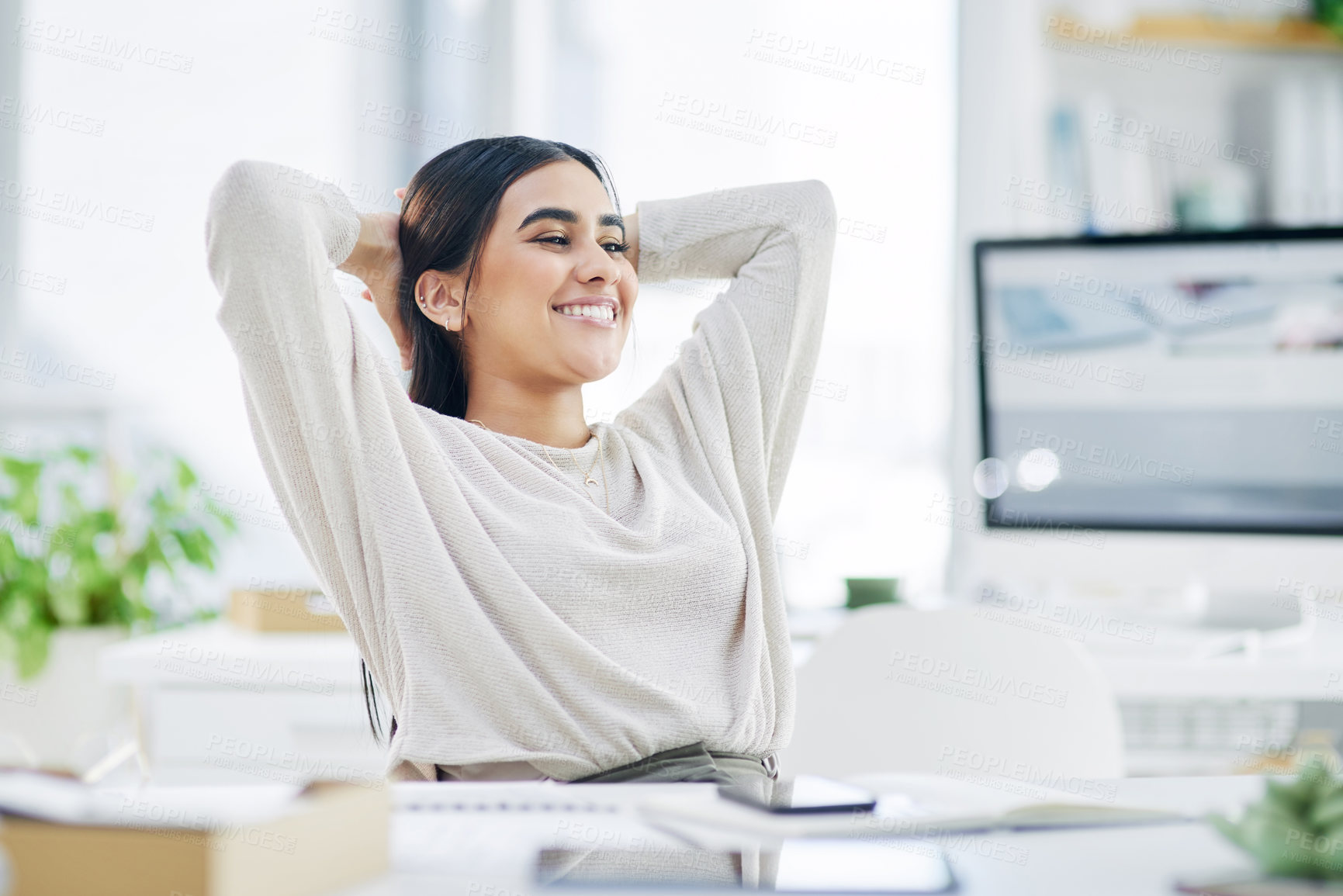 Buy stock photo Shot of a young businesswoman taking a break while working in an office