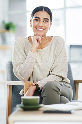 Buy stock photo Portrait of a confident young businesswoman sitting in an office