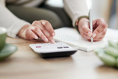 Buy stock photo Closeup shot of an unrecognisable businesswoman writing notes while using a calculator in an office