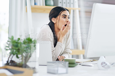Buy stock photo Shot of a young businesswoman looking shocked while using a computer in an office