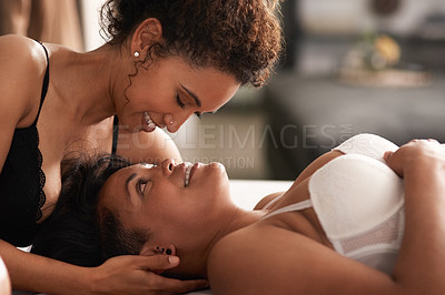 Buy stock photo Shot of a young couple being intimate in their bedroom