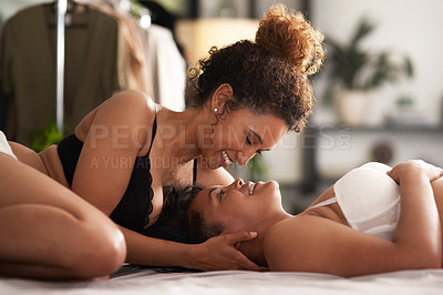 Buy stock photo Shot of a young couple being intimate in their bedroom