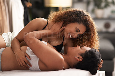 Buy stock photo Shot of a young couple being intimate in their bedroom