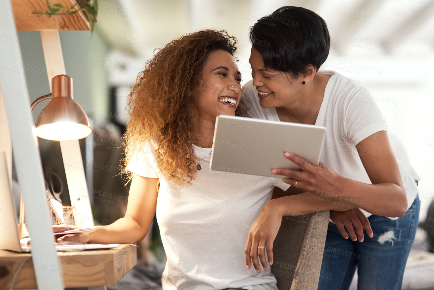 Buy stock photo Shot of a couple using a tablet in the lounge at home