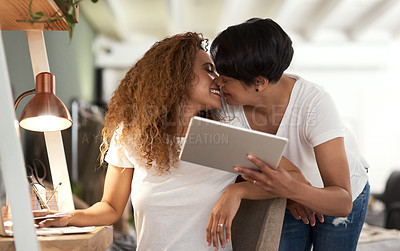 Buy stock photo Shot of a couple using a tablet in the lounge at home